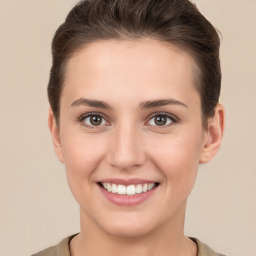 Joyful white young-adult female with short  brown hair and brown eyes