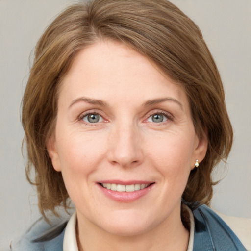 Joyful white young-adult female with medium  brown hair and blue eyes