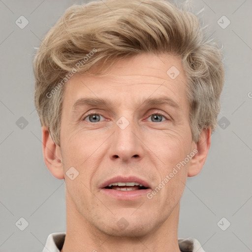 Joyful white adult male with short  brown hair and grey eyes