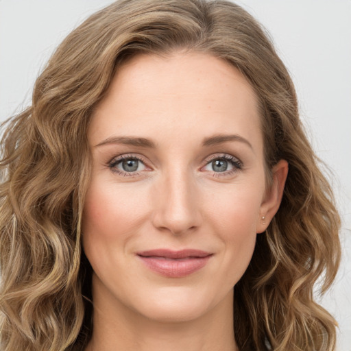 Joyful white young-adult female with long  brown hair and green eyes