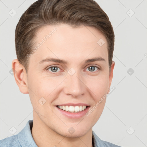 Joyful white young-adult male with short  brown hair and grey eyes