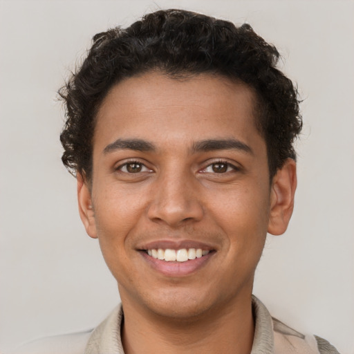 Joyful latino young-adult male with short  brown hair and brown eyes