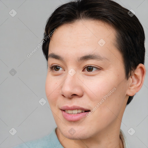 Joyful asian young-adult male with short  brown hair and brown eyes