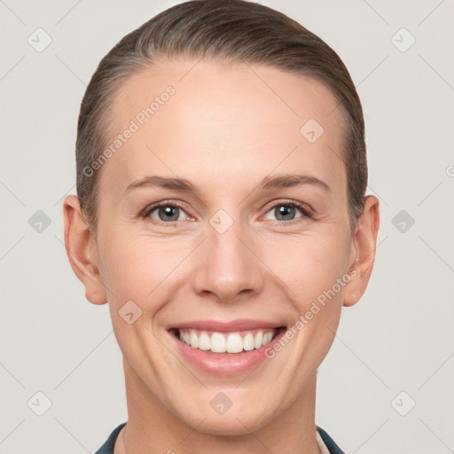 Joyful white young-adult female with short  brown hair and grey eyes