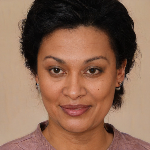 Joyful latino adult female with medium  brown hair and brown eyes