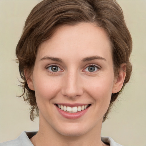 Joyful white young-adult female with medium  brown hair and green eyes