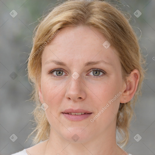 Joyful white adult female with medium  brown hair and blue eyes