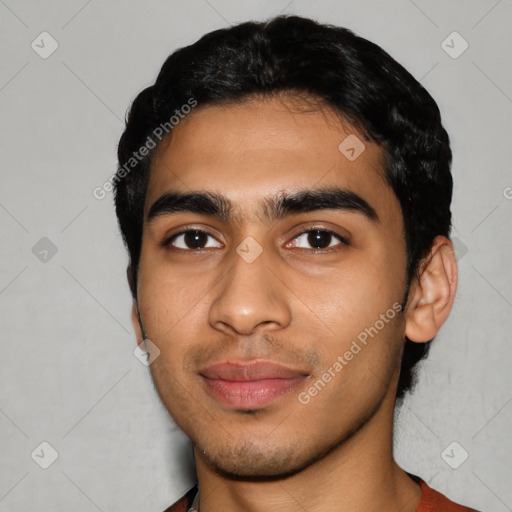 Joyful latino young-adult male with short  black hair and brown eyes