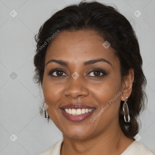 Joyful black adult female with medium  brown hair and brown eyes