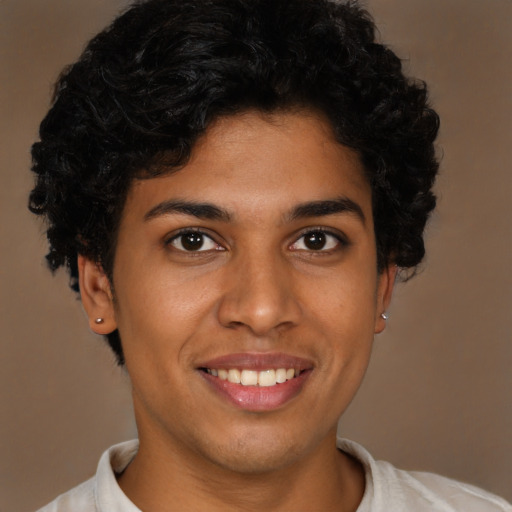 Joyful latino young-adult male with short  brown hair and brown eyes