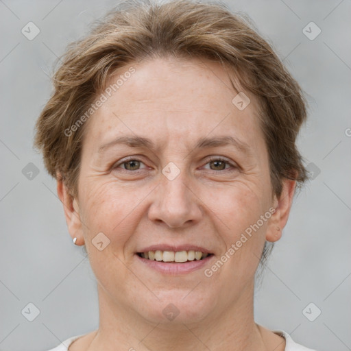 Joyful white adult female with short  brown hair and grey eyes