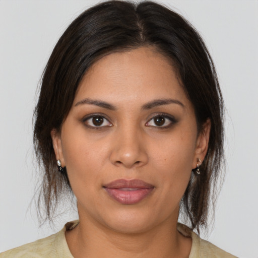 Joyful latino young-adult female with medium  brown hair and brown eyes