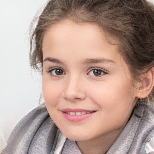 Joyful white child female with medium  brown hair and brown eyes