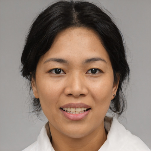 Joyful asian adult female with medium  black hair and brown eyes