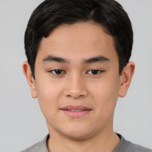Joyful asian young-adult male with short  brown hair and brown eyes