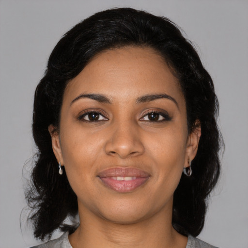 Joyful black young-adult female with medium  black hair and brown eyes