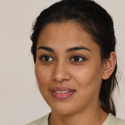 Joyful latino young-adult female with medium  brown hair and brown eyes