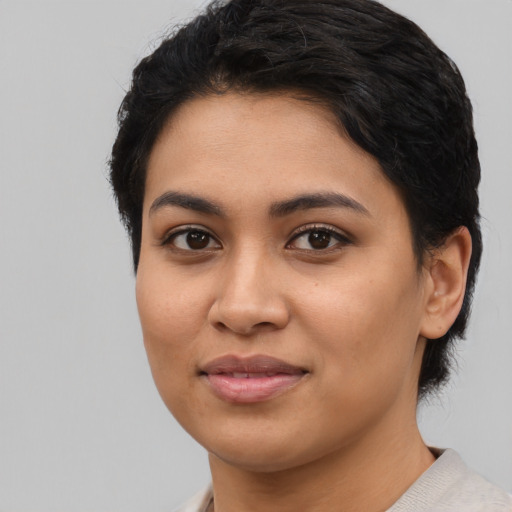 Joyful latino young-adult female with medium  black hair and brown eyes