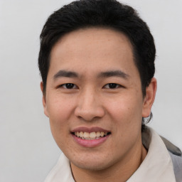 Joyful asian young-adult male with short  black hair and brown eyes