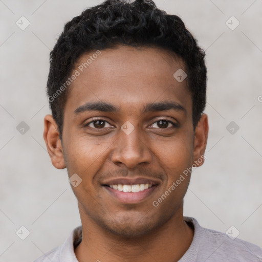 Joyful black young-adult male with short  black hair and brown eyes