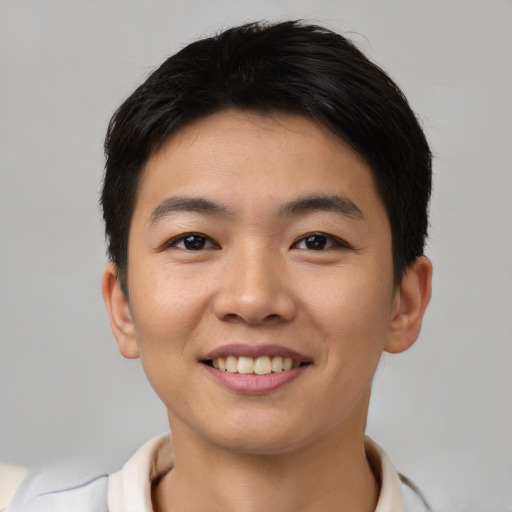 Joyful asian young-adult male with short  black hair and brown eyes
