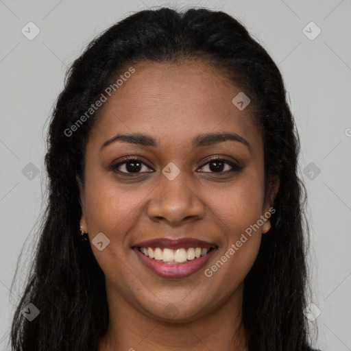 Joyful black young-adult female with long  brown hair and brown eyes