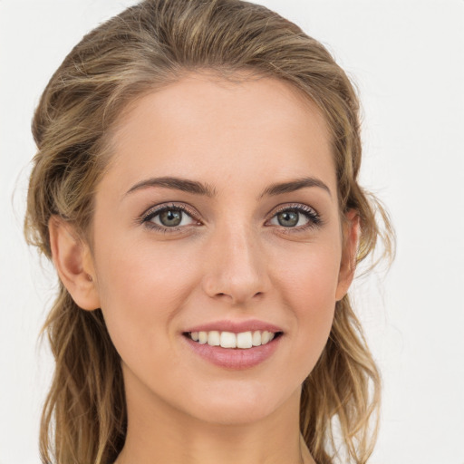 Joyful white young-adult female with long  brown hair and blue eyes