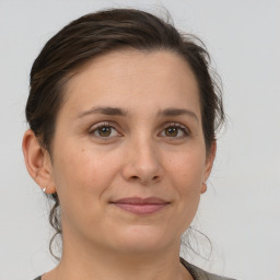 Joyful white adult female with medium  brown hair and brown eyes