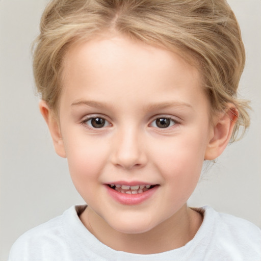 Joyful white child female with short  blond hair and brown eyes