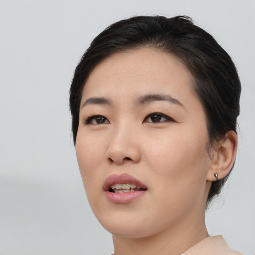 Joyful asian young-adult female with short  black hair and brown eyes