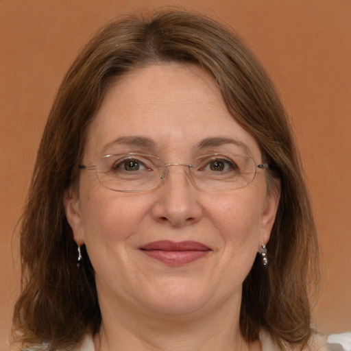 Joyful white adult female with medium  brown hair and green eyes