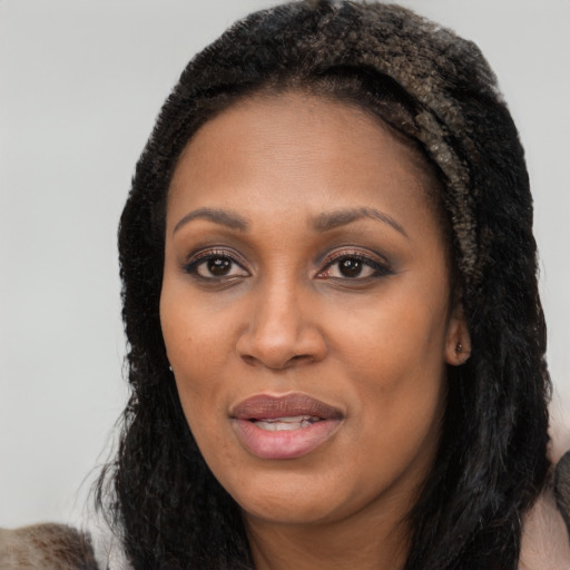Joyful white adult female with long  black hair and brown eyes