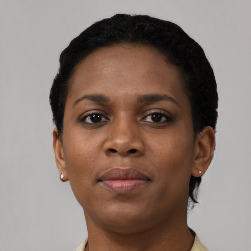 Joyful black young-adult female with short  black hair and brown eyes