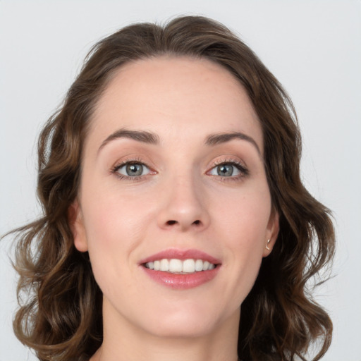 Joyful white young-adult female with medium  brown hair and green eyes