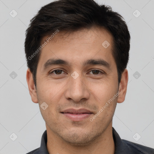 Joyful white young-adult male with short  black hair and brown eyes