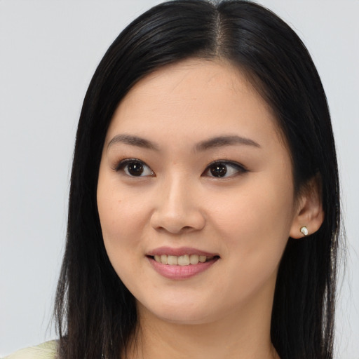 Joyful asian young-adult female with long  black hair and brown eyes