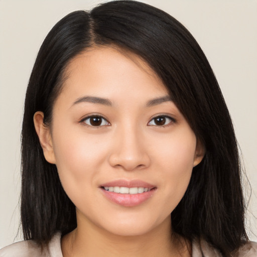 Joyful asian young-adult female with long  brown hair and brown eyes