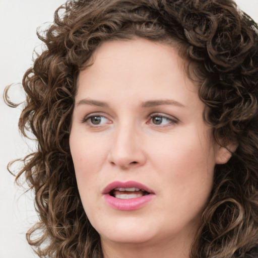 Joyful white young-adult female with medium  brown hair and green eyes