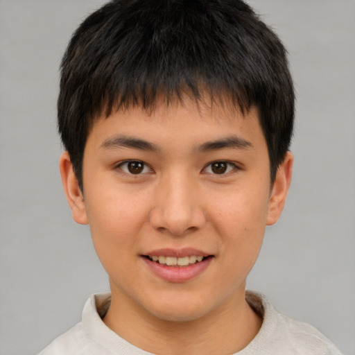 Joyful asian child male with short  brown hair and brown eyes