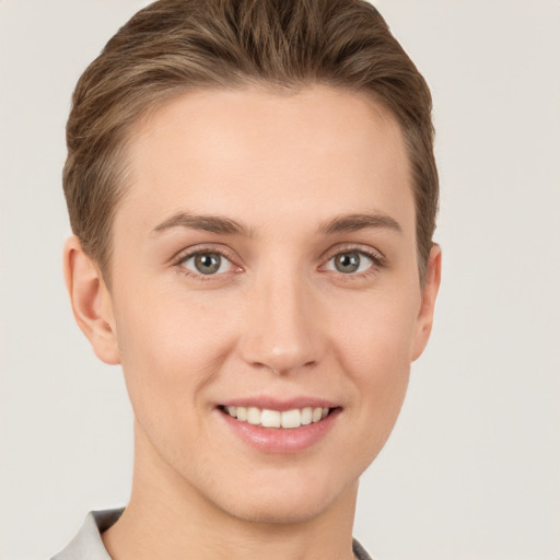 Joyful white young-adult female with short  brown hair and grey eyes