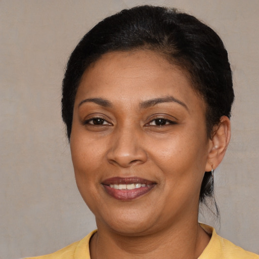 Joyful latino adult female with short  brown hair and brown eyes