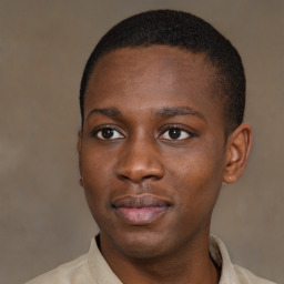 Joyful black young-adult male with short  brown hair and brown eyes