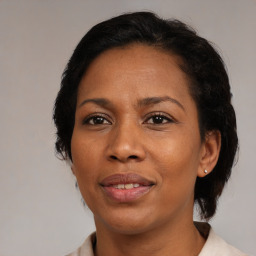 Joyful black adult female with medium  brown hair and brown eyes