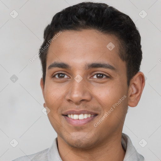 Joyful latino young-adult male with short  brown hair and brown eyes