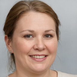 Joyful white adult female with medium  brown hair and grey eyes