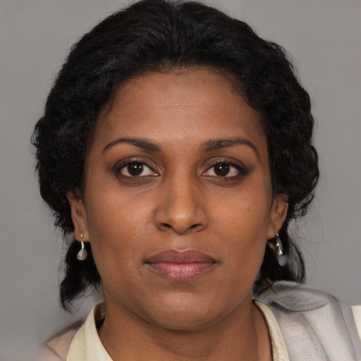 Joyful black young-adult female with medium  brown hair and brown eyes