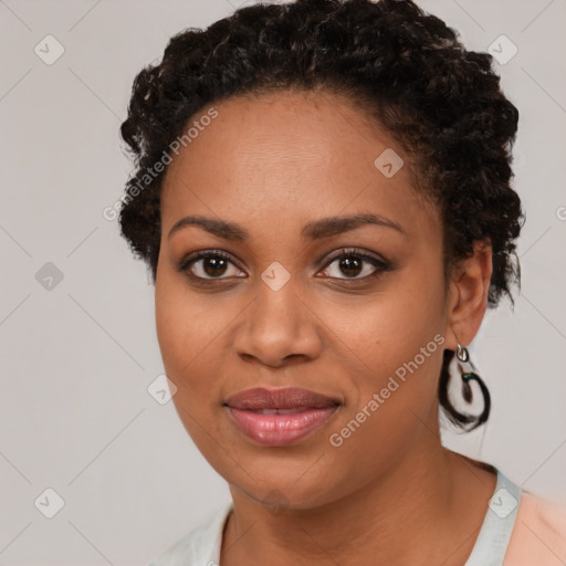 Joyful black young-adult female with short  brown hair and brown eyes