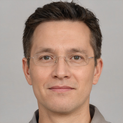 Joyful white adult male with short  brown hair and brown eyes