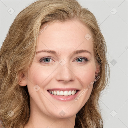 Joyful white young-adult female with long  brown hair and blue eyes