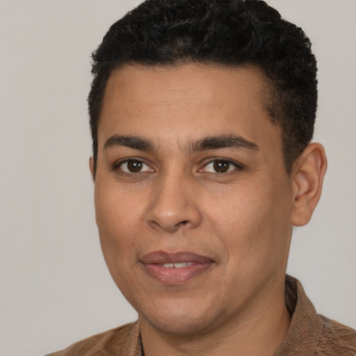 Joyful latino young-adult male with short  brown hair and brown eyes